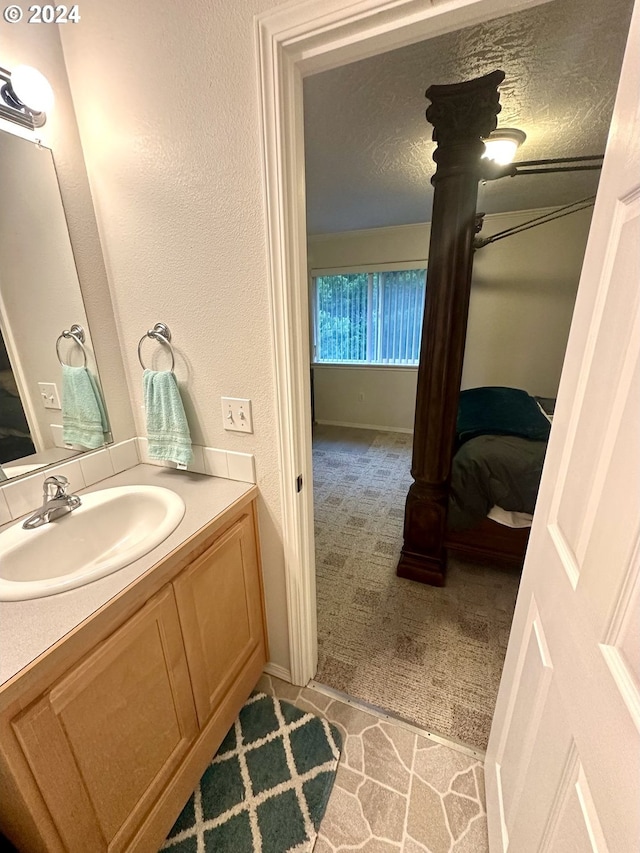 146 28th St, Long Beach, WA 98631 - bathroom featuring vanity, connected bathroom, baseboards, and a textured ceiling