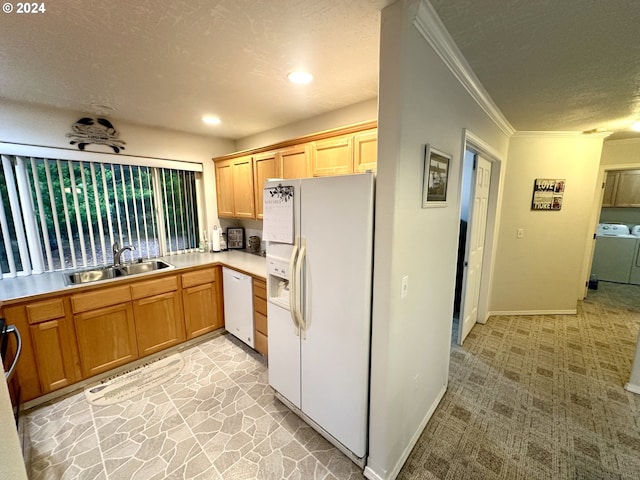 146 28th St, Long Beach, WA 98631 - kitchen with white appliances, a sink, washing machine and clothes dryer, a textured ceiling, and ornamental molding