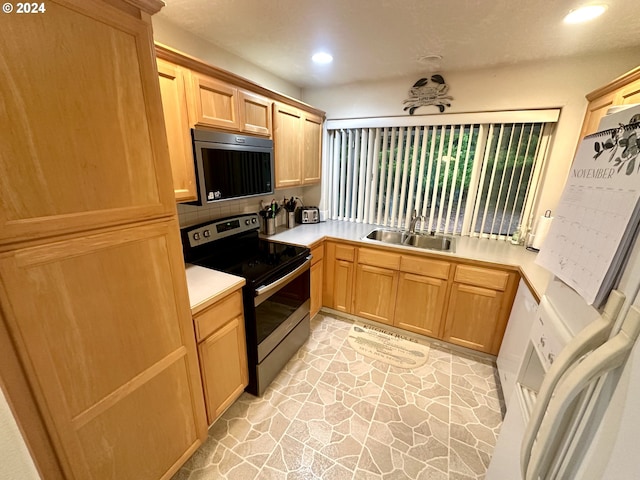 146 28th St, Long Beach, WA 98631 - kitchen with stainless steel appliances, a sink, light countertops, recessed lighting, and light brown cabinets