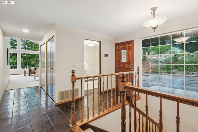 interior space with visible vents and an upstairs landing