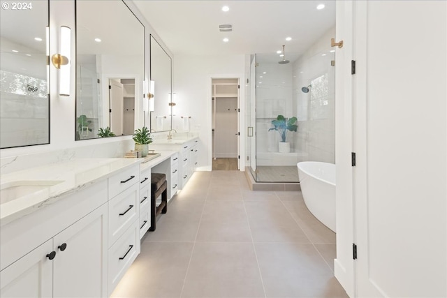 bathroom featuring vanity, shower with separate bathtub, and tile patterned flooring