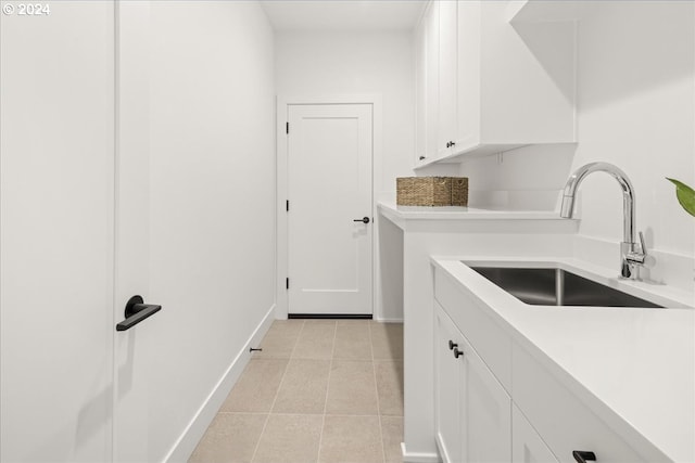 washroom with light tile patterned flooring and sink