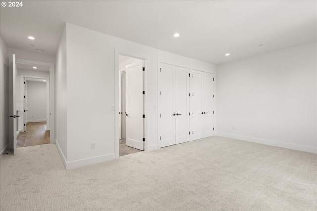 unfurnished bedroom featuring light colored carpet