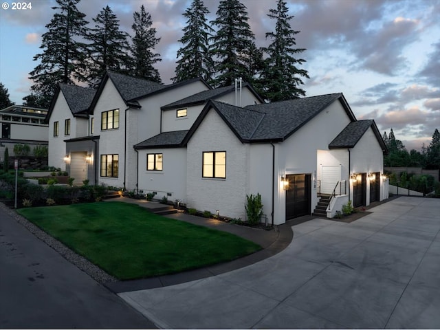 view of front of property featuring a garage and a yard