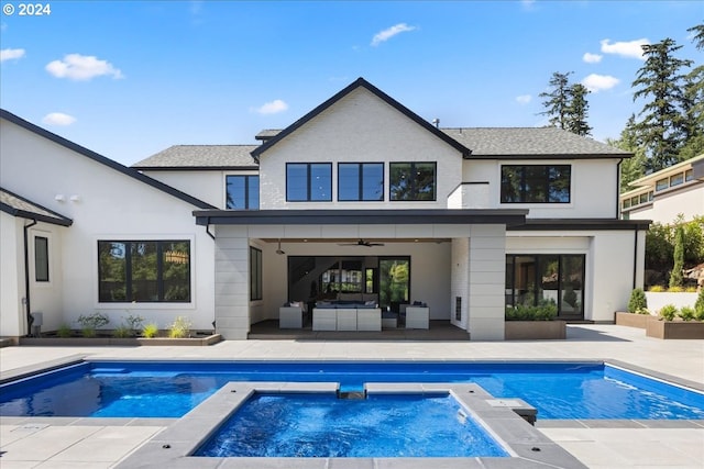 rear view of property featuring an outdoor living space, a patio, ceiling fan, and a pool with hot tub