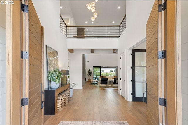 foyer with a towering ceiling and light hardwood / wood-style floors