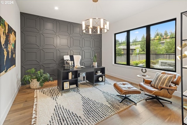 office area featuring a notable chandelier and light wood-type flooring