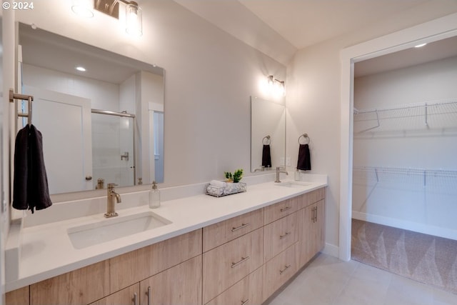 bathroom featuring walk in shower, tile patterned flooring, and vanity