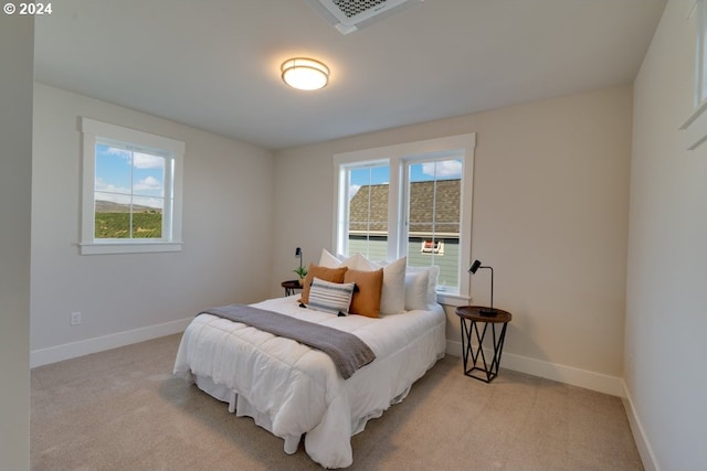 bedroom with light colored carpet