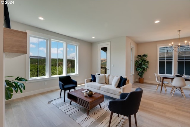 living room featuring a chandelier and light hardwood / wood-style flooring