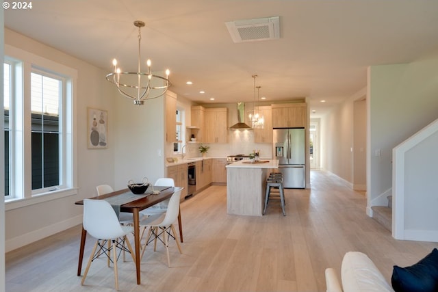 dining room featuring an inviting chandelier, light wood-type flooring, and sink