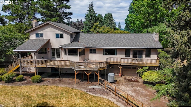 view of front of house featuring central AC, a garage, and a front yard