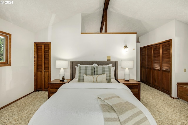 carpeted bedroom featuring lofted ceiling with beams, a textured ceiling, and a closet