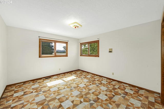 empty room with a textured ceiling