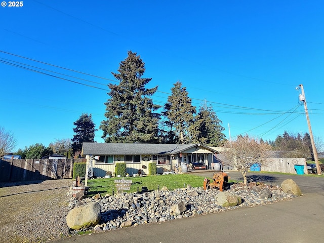 single story home with covered porch and a front yard