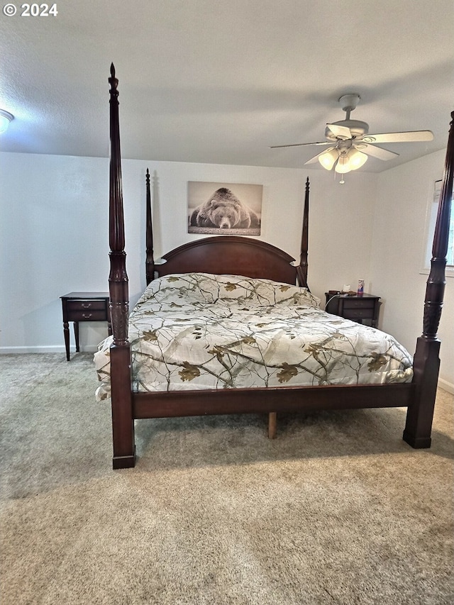 carpeted bedroom featuring a textured ceiling and ceiling fan