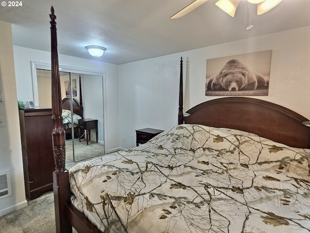 carpeted bedroom featuring ceiling fan and a closet