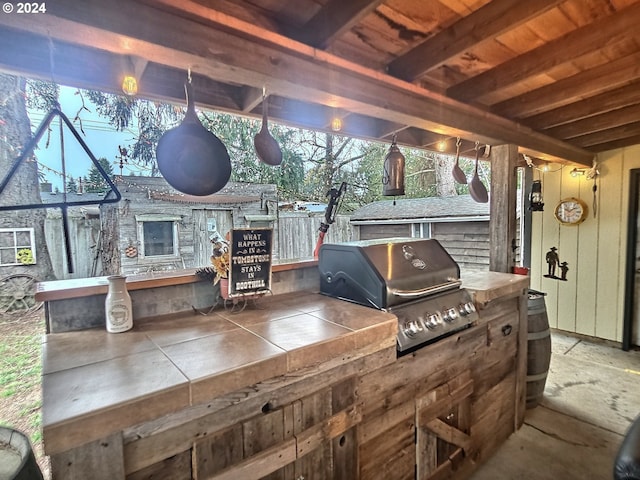 view of patio featuring an outdoor kitchen and a grill