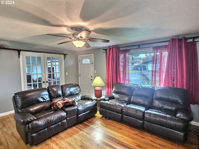 living room featuring hardwood / wood-style floors, plenty of natural light, and french doors