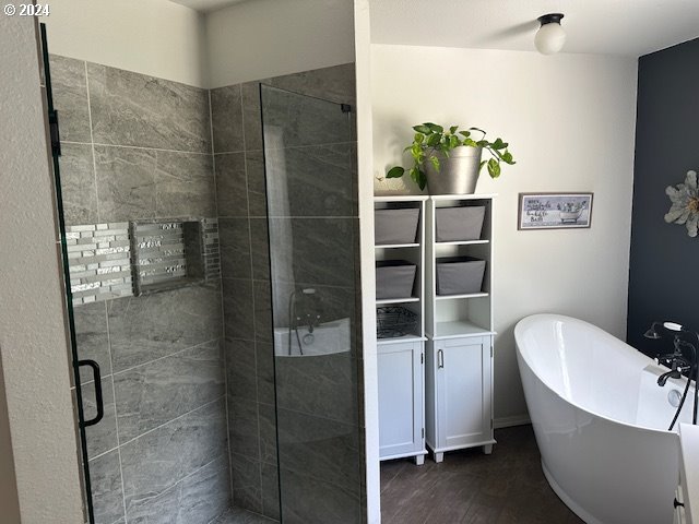 bathroom with wood-type flooring and separate shower and tub