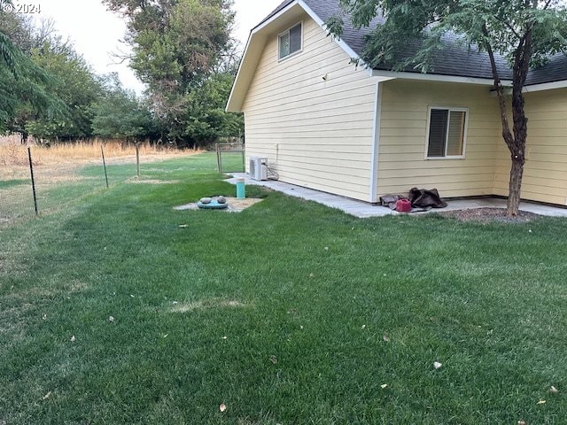 view of property exterior featuring central AC unit and a yard