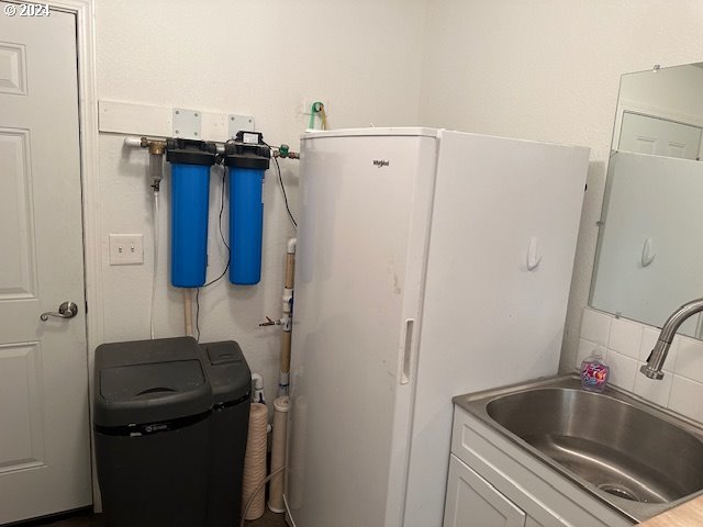 clothes washing area with sink