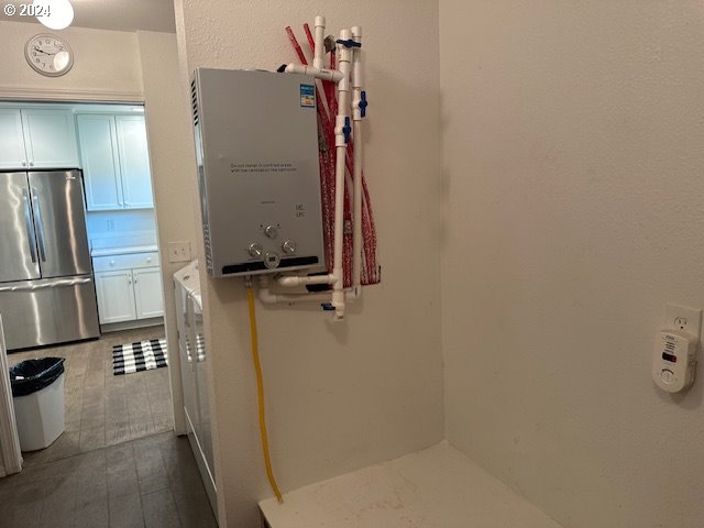 bathroom with tile patterned floors and water heater