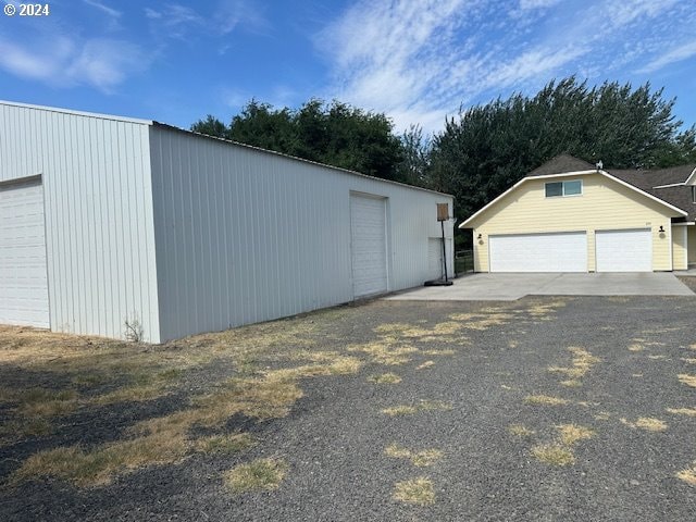 exterior space with an outbuilding and a garage