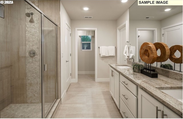 bathroom featuring wood-type flooring, vanity, and walk in shower