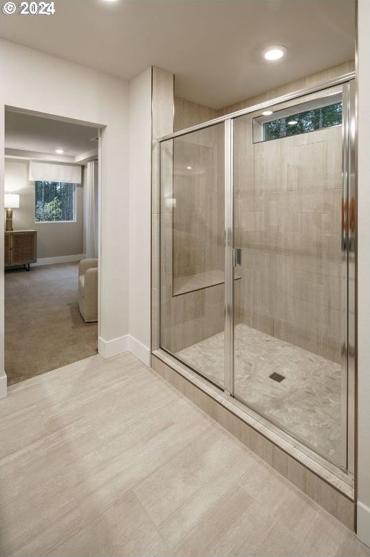 bathroom with a shower with door