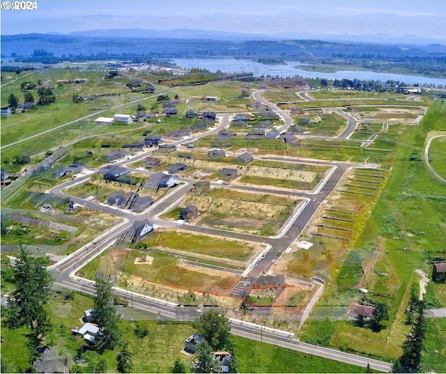 birds eye view of property with a rural view and a water view