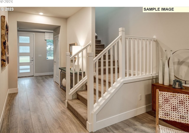 stairway featuring wood-type flooring