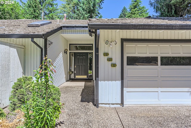 doorway to property with a garage