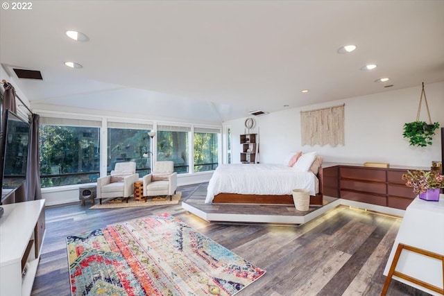 bedroom featuring multiple windows, dark wood-type flooring, and vaulted ceiling