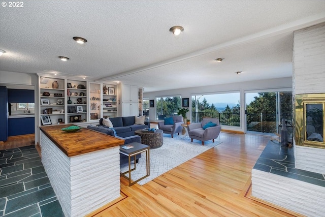 living room featuring hardwood / wood-style floors and a textured ceiling