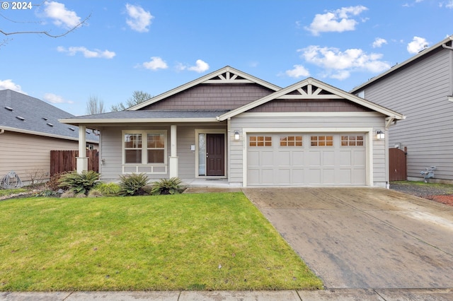 view of front of property with a front yard and a garage