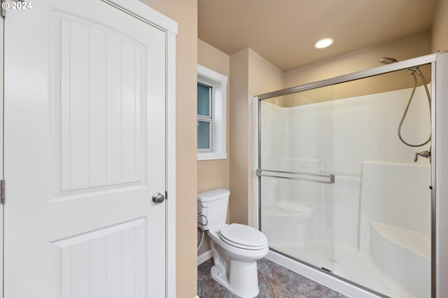 bathroom with an enclosed shower and toilet