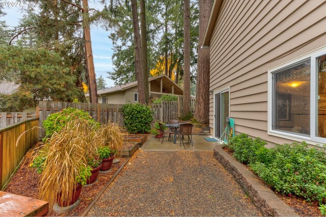13525 SW Fircrest Ct, Beaverton, OR 97008 - fenced backyard featuring a patio and a garden