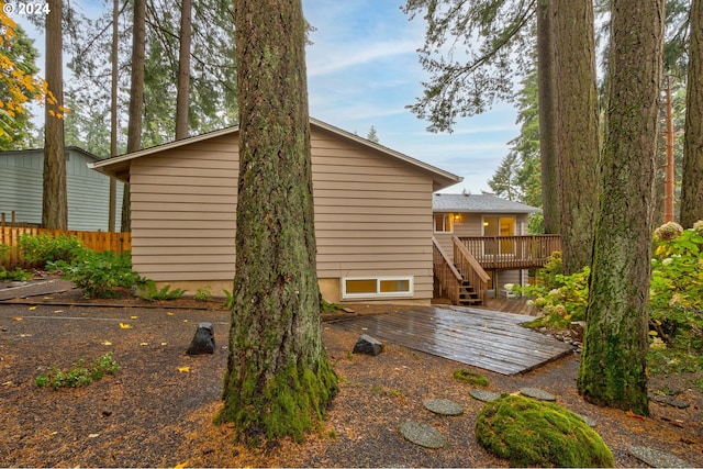 view of side of property featuring a wooden deck