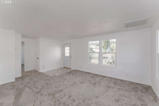 unfurnished room with light carpet