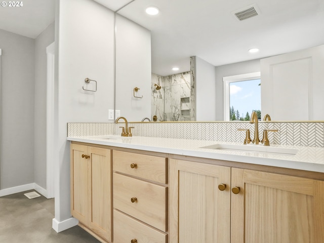 bathroom with vanity, backsplash, walk in shower, and concrete floors