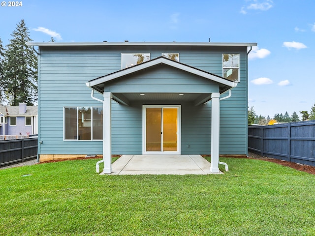 rear view of house with a patio area and a yard