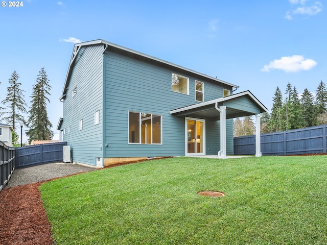 rear view of house with a lawn