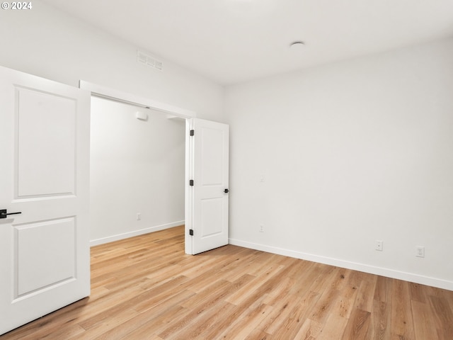 unfurnished room with light hardwood / wood-style floors