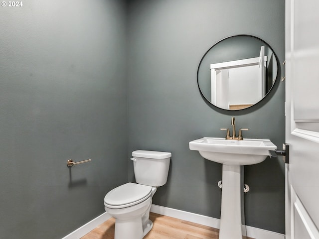 bathroom with hardwood / wood-style floors and toilet