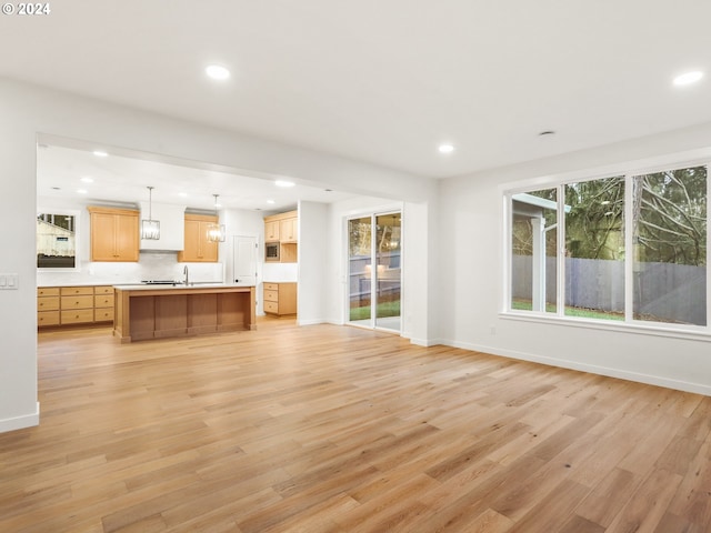 unfurnished living room with light hardwood / wood-style flooring