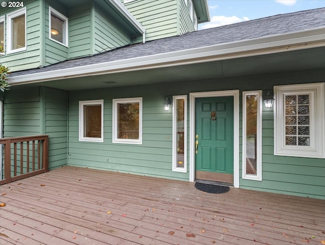 view of exterior entry featuring a wooden deck