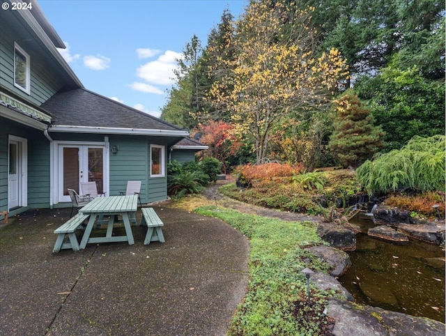 view of yard featuring a patio and french doors