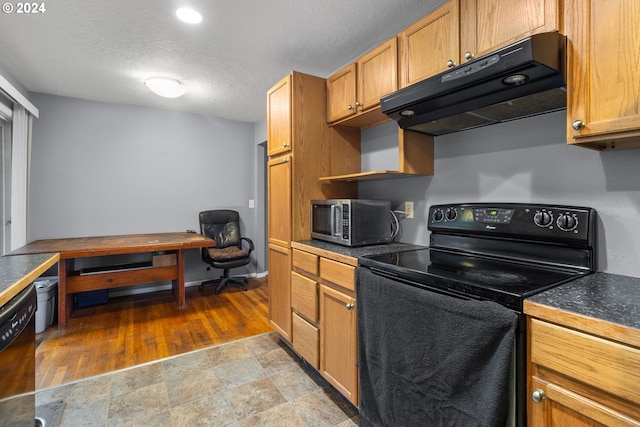 kitchen featuring a textured ceiling and black appliances