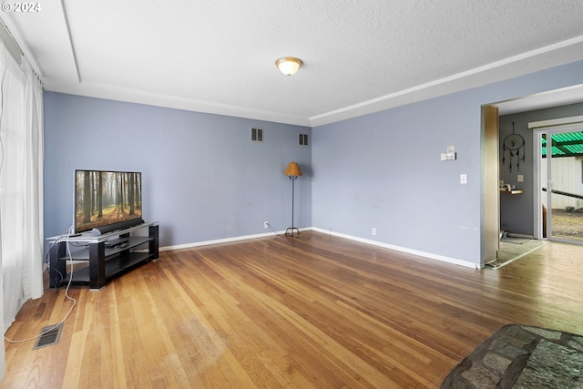 living room with wood-type flooring and a textured ceiling